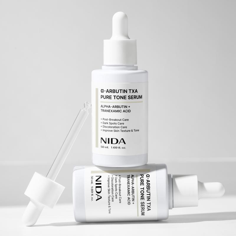 NIDA alpha-Arbutin TXA Pure Tone Serum Dark Spots Skin Tone GlowContains Batteries or Cells?: None  
 Dangerous Goods or Hazardous Materials: None  
 Aerosols: No  
 Flammable Liquid: No  
 Container Type: Bottle  
 Benefits: Hydrating, Anti-aging, Soothing, Smoothing, Brightening, Nourishing, Uneven Skin Tone  
 Region of Origin: Korea  
 Benefits: Revitalizing, Soothing, Pore Control, Nourishing, Dark Circles, Softening, Rejuvenate, Smoothing, Anti-Wrinkle, Brightening, Hydration, Plump, Repair, Oil Control, Moisturizing, Anti-Aging, Even Out Skin Tone & Texture  
 Shelf Life: 24 Months  
 Product Form: Serum  
 Age Group: Adults  
 Skin Type: All Skin Types  
 Pack Type: Single Item  
 Contains Alcohol or Aerosol: Contains Neither  
 Net Weight: 100G  
 Ingredients: Water, Propanediol, Glycerin, Niacinamide, Tranexamic Acid, 1,2-Hexanediol, Acetyl Glucosamine, Alpha-Arbutin, Butylene Glycol, Polyglyceryl-10 Caprylate/Caprate, Propoxytetramethyl Piperidinyl Dimethicone, Sodium Polyacryloyldimethyl Taurate, Theobroma Cocoa (cocoa) Extract, Trideceth-6, Ethylhexylglycerin, Disodium EDTA, Allantoin, Panthenol, Xanthan Gum, Tocopherol, Propylene Glycol, Sodium  Hyaluronate, Hydroxypropyltrimonium Hyaluronate, Licorice Root Glabra Licorice root Extract, Astragalus Membraneaceus root Extract, Glutathione, Madecassoside, Centella Asiatica Extract, Asiaticoside, Hydrolyzed Hyaluronic Acid, Sodium Acetylated  Hyaluronic Acid, Phenoxyethanol, Hyaluronic Acid, Sodium Hyaluronate Crosspolymer, Hydrolyzed Sodium Hyaluronate, Potassium Hyaluronate  
 Manufacturer: Proso IncML Clinic  for Wellness